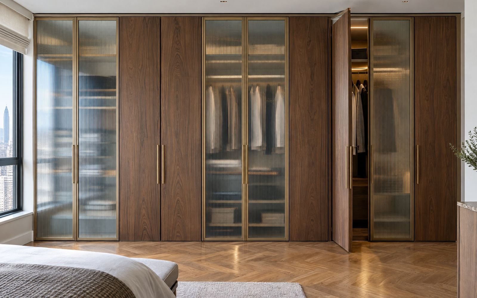 Custom closet doors in reeded glass and walnut with brass pulls, design concept